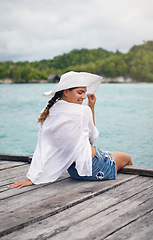 Image showing Island, travel and woman relax on deck for holiday, summer vacation and weekend getaway in Maldives. Traveling, tropical ocean and female person on luxury resort for tourism, happiness and freedom