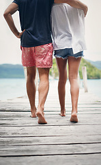 Image showing Couple, relax walking and beach deck on holiday with freedom and love in summer in Thailand. Tropical nature, sea and back of people on a boardwalk walk in the sun on vacation break by ocean water