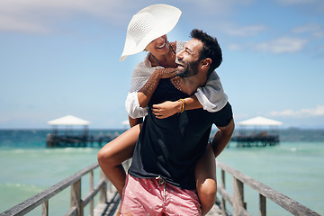 Image showing Couple, piggyback and beach deck on a tropical island with love and laughing on holiday. Summer vacation, travel smile and Maldives walk in nature with freedom and happiness by the ocean and sea