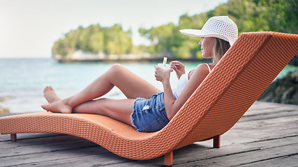 Image showing Chair, ocean and woman relax with a drink outdoor on a vacation, holiday or adventure in nature. Female person on tropical lounger, travel and deck with lake water in summer for zen, peace and calm