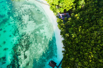 Image showing Ocean, coastline and tropical island with clear water ariel angle view in nature on vacation for scenery. Sea, beach and summer paradise for a relaxing vacation with sunshine for traveling and peace.