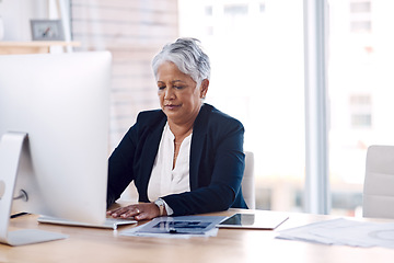 Image showing Focus, computer and search with a business woman or CEO working in her corporate office. Serious, professional and leadership with a senior female manager at work typing an email or proposal