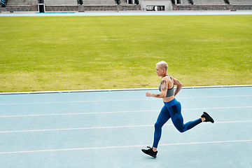 Image showing Woman, stadium and athlete running on track for exercise, cardio training or workout outdoors. Fit, active or sporty female person or runner in sports fitness, run or race for athletics or wellness