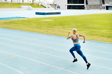 Image showing Woman, race and athlete running track on stadium for exercise, cardio training or workout outdoors. Fit, active or sporty female person or runner in sports fitness, run or athletics for wellness