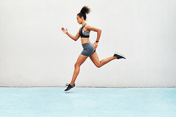 Image showing Fitness, action and jump of running woman for exercise, cardio training or workout outdoors. Fit, active or sport female person or runner in sports motivation for power run or jumping on mockup space