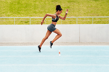 Image showing Woman, cardio and running on track in training, physical exercise or workout on stadium. Active, fit or sporty female person, athlete or runner in sports run, race or competition for healthy wellness