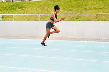 Image showing Woman, cardio and running on stadium track for training, physical exercise or workout. Active, fit or sporty female person, athlete or runner in sports run, race or competition for healthy wellness