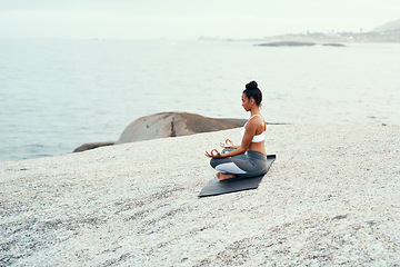 Image showing Yoga, meditation and woman on a beach with lotus pose, wellness and fitness. Pilates, sea and female person on sand with peace in nature feeling relax and calm with spiritual and holistic mockup