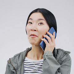 Image showing Gossip, phone call and Asian woman talking in studio isolated on a white background. Listening, cellphone and female person speaking, discussion or communication for conversation, news or online chat