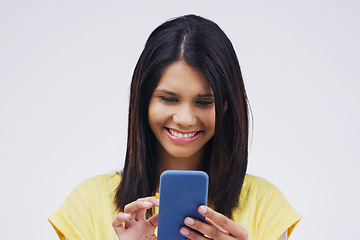 Image showing Typing, smile and woman with a cellphone, connection and network against a white studio background. Female person, girl or model with a smartphone, online reading or search internet with website info