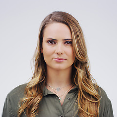 Image showing Face, serious student and a woman in studio with confidence, natural beauty and front. Portrait of a young female model from London isolated on a white background with concentration and focus