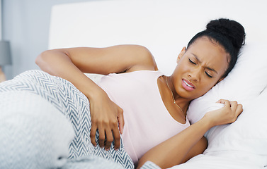 Image showing Stomach, pain and problem with woman in bed for menstruation, medical and pms. Endometriosis, healthcare and period with person suffering in bedroom at home for uncomfortable, bloated and sad