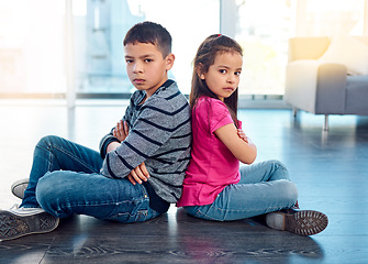 Image showing Portrait, children and sitting with arms crossed after fight, anger and backs together on floor in house. Angry, brother and sister in home living room, fighting or argument, conflict or problem.