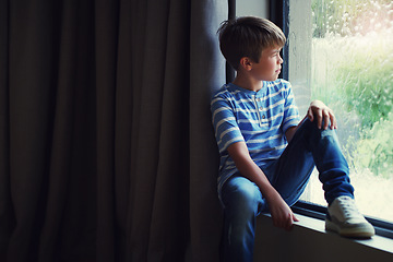 Image showing Boy child, rain and thinking by window with sad face, mental health and mockup space in home. Male kid, raining and think by glass with depression, mock up or fear with problem, winter and frustrated