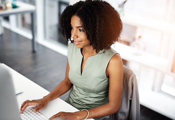 Image showing Smile, research and business woman on a computer in office from above, happy and satisfied with web search. Online, review and African female person smile for report, proposal or creative inspiration