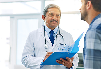 Image showing Senior doctor, man patient and results with medical consultation and discussion in clinic. Hospital, wellness consulting and health insurance checklist of a healthcare and professional talking