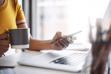 Image showing Smartphone, hands and searching or laptop, coffee and work in home office or shopping, browsing and mobile communication. Closeup, woman and social media, internet or online work with notebook