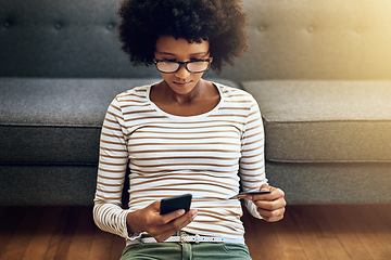 Image showing Black woman, phone and credit card for ecommerce, payment or purchase in living room at home. African female person or shopper sitting on floor with smartphone or debit for online shopping or banking