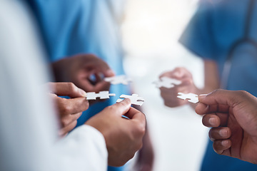 Image showing Hands, puzzle and collaboration of medical doctors in hospital for team building, synergy and planning. Teamwork, nurses and jigsaw pieces for healthcare, solution and strategy, cooperation and trust