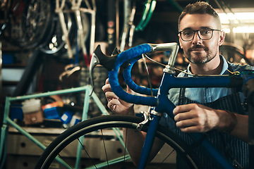 Image showing Portrait, serious and repair man in bicycle shop working in store and cycling workshop. Face, bike mechanic and confident male person, professional and mature technician from Canada with glasses.