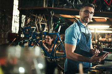 Image showing Portrait, calculator and repair man in bicycle shop working in store for sales. Face, bike mechanic and serious male professional from Canada with glasses, pride and mature in cycling workshop.