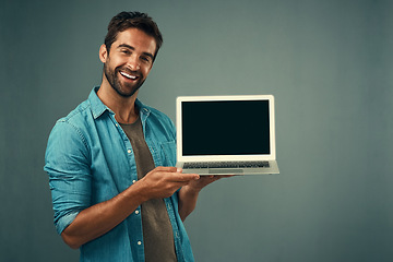 Image showing Happy man, laptop and mockup screen for advertising or marketing against a grey studio background. Portrait of male person with smile showing computer display or copy space for branding advertisement