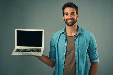 Image showing Happy man, laptop and mockup screen for advertising or marketing against a grey studio background. Portrait of male person with smile showing computer display or mock up space for advertisement