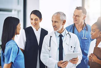 Image showing Senior man, team or group of doctors with tablet, smile or leadership for discussion, planning or together in hospital. Medical men, leader and experience for teamwork, women or touchscreen in clinic