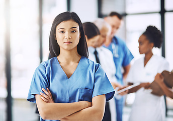 Image showing Healthcare, confidence and portrait of nurse with arms crossed in hospital for support, career in medicine and care. Health, clinic and Asian woman caregiver, serious face of medical professional.