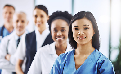 Image showing Team, happy woman leader and portrait of doctors and nurses in hospital, teamwork and healthcare. Health, diversity and medicine, confident doctor and group of medical employees in row with smile.