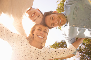 Image showing Face portrait, sky and happy family hug, love and solidarity circle of child, mom and dad bonding in nature park. Care, fresh air and below view of people smile for natural sunshine, freedom or peace