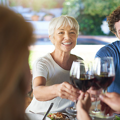 Image showing Senior woman, group and wine glass for toast at table for celebration, food or friends at lunch event. People, together and celebrate with alcohol, glasses or support at party, dinner and family home