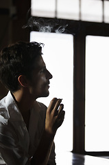 Image showing Smoking, man and thinking in pub with cigarette or male model or vapor customer and smoker unhealthy on bokeh. Habit, addiction and male person with tobacco or in thought or relaxing and in a club