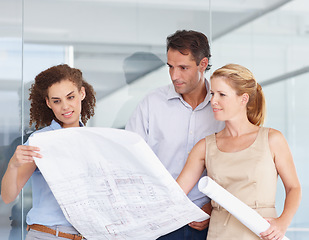 Image showing Architect team, blueprint and planning in construction, meeting or collaboration at office. Group or business people looking at document, paperwork or floor plan for architecture project at workplace