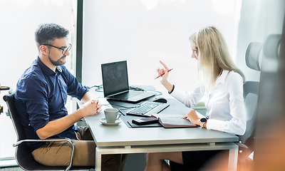 Image showing Business meeting. Client consulting. Confident business woman, real estate agent, financial advisor explaining details of project or financial product to client in office.