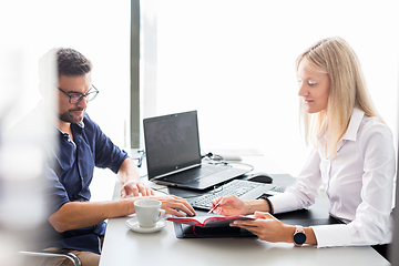 Image showing Business meeting. Client consulting. Confident business woman, real estate agent, financial advisor explaining details of project or financial product to client in office.