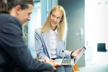 Image showing Business meeting. Client consulting. Confident business woman, real estate agent, financial advisor explaining details of project or financial product to client in office.