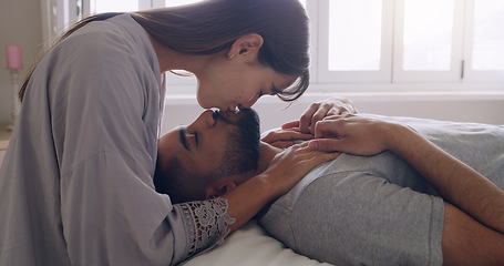 Image showing Couple, love and kiss in bed, room and romance of intimacy, special moment and bonding together at home. Young man, woman and kissing partner for happy relationship, honeymoon and care in the morning