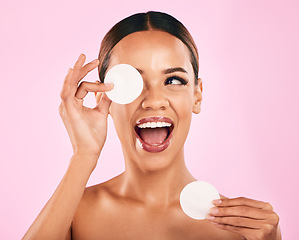 Image showing Happy woman, face and cotton pad in beauty, makeup removal or skincare cosmetics against a pink studio background. Excited female person or model with cosmetic swab for cleaning or facial treatment