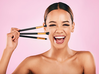 Image showing Happy woman, portrait and makeup brushes for beauty cosmetics against a pink studio background. Excited female person with cosmetic tools or equipment for grooming, skin products or facial treatment