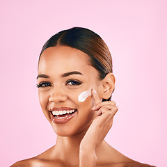 Image showing Happy woman, portrait smile and skincare cream for beauty moisturizer against a pink studio background. Female person or model smiling in happiness for lotion, cosmetic products or facial treatment