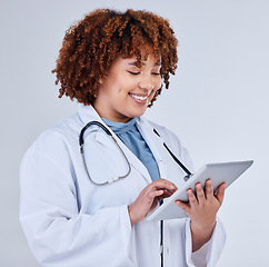 Image showing Tablet, doctor or african woman isolated on a white background for healthcare research, clinic or telehealth services. Nurse or medical person typing on digital tech, paperless or software in studio