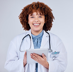 Image showing Tablet, doctor portrait and woman isolated on a white background of happy healthcare research or telehealth services. Face of african medical person typing on digital tech and paperless app in studio