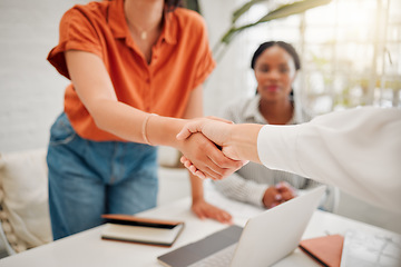 Image showing Businesswomen shaking hands in the office for a deal, partnership or corporate collaboration. Meeting, welcome and closeup of female employees with a handshake for an onboarding, hiring or agreement.