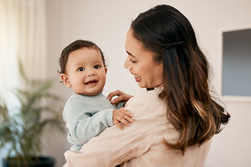 Image showing Family, love and mother holding baby for bonding, quality time and loving embrace together at home. New born, motherhood and happy mom carry infant for care, support and affection in living room