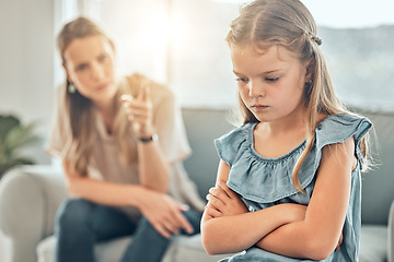 Image showing Angry lecture from mom, sad child and discipline in living room, problem with naughty girl behaviour in home. Scolding, punishment and frustrated mother, stubborn kid and communication with anger.