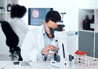 Image showing Science, particles and scientist analyzing with a microscope in a medical laboratory with concentration. Biotechnology, pharmaceutical and male researcher working on scientific project for healthcare