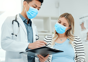 Image showing Healthcare, woman and doctor with a clipboard, consultation and conversation for diagnosis. Female person, patient or medical professional with a document, explain insurance or symptoms in a hospital