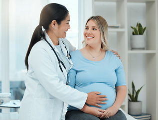 Image showing Healthcare, comfort and doctor with a pregnant woman in a clinic touching her belly for support. Maternity, wellness and female nurse hugging a patient with pregnancy during a prenatal consultation.