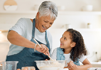 Image showing Grandmother, happy or child baking in kitchen as a happy family with young girl learning cookies recipe. Mixing cake, development or grandma smiling or teaching kid to bake with eggs, butter or flour